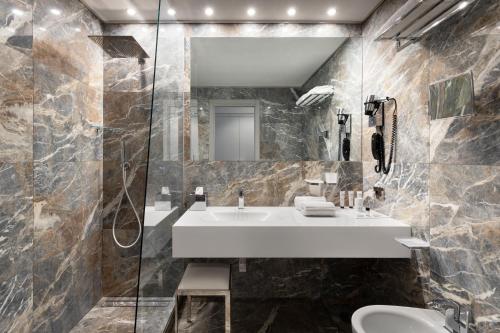 a bathroom with a sink and a mirror at LHP Napoli Palace & SPA in Naples