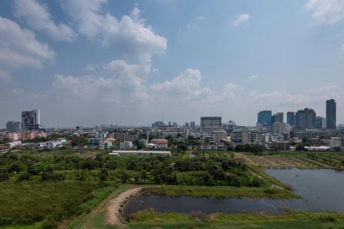 a view of a city with a body of water at Maitria Hotel Rama 9 Bangkok - A Chatrium Collection in Bangkok