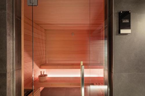 a sauna in a bathroom with a glass wall at LHP Napoli Palace & SPA in Naples