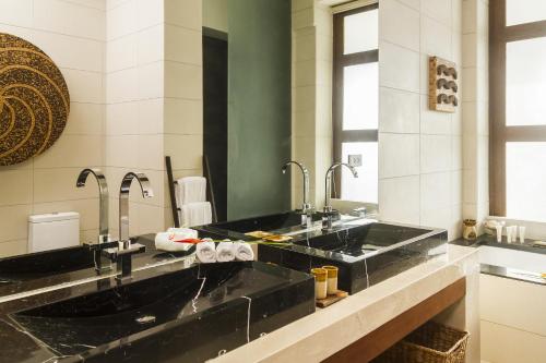 a bathroom with two sinks and a large mirror at Kandaya Resort in Daanbantayan