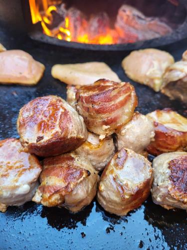 a bunch of food is cooking on a grill at Hotel Schloss Walbeck in Geldern