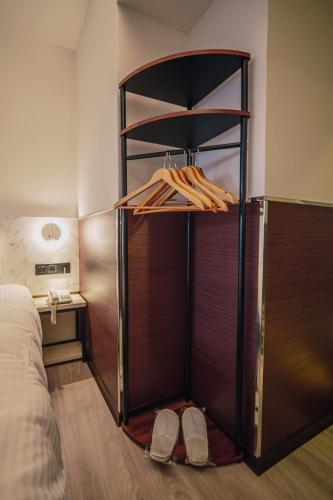 a room with a bed and a closet with shoes at Hub Hotel - Songshan Airport Branch in Taipei