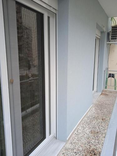 a glass door of a house with a window at Central Home Kavala "private parking" in Kavala
