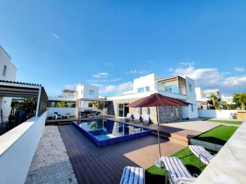 a house with a swimming pool and a patio at Villa utopia in Paphos City