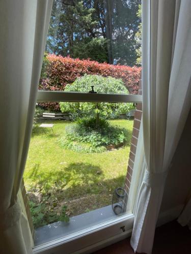 an open window with a view of a yard at Rowan Brae Historic Guesthouse in Blackheath
