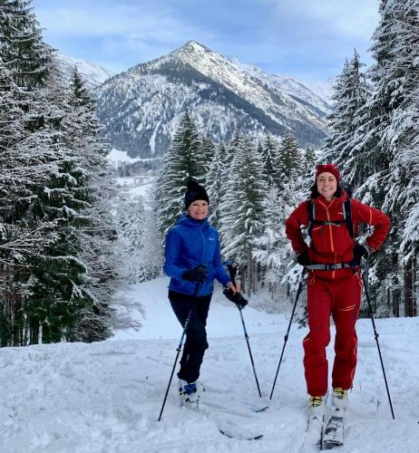 two people standing on skis in the snow at Bergesgrün in Oberstdorf