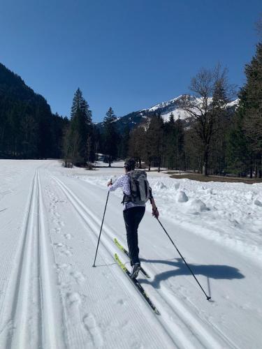 a person is cross country skiing in the snow at Bergesgrün in Oberstdorf