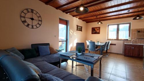 a living room with a couch and a table at Sudecka Ostoja z Balią i Sauną in Lubawka