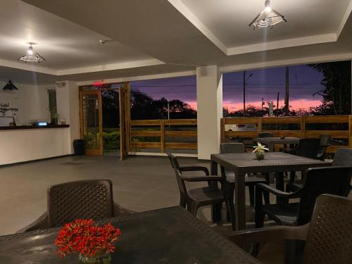 um pátio com uma mesa e cadeiras e um pôr-do-sol em Hotel Ummagumma em Montañita