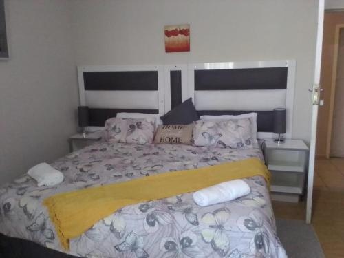a bedroom with a large bed with towels on it at Thatch Haven Guesthouse in Mahikeng