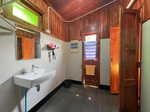 ein Bad mit einem Waschbecken und einem Fenster in der Unterkunft กิ่วลม - ชมลคอร Kiwlom - Chomlakorn, Lampang, TH in Lampang