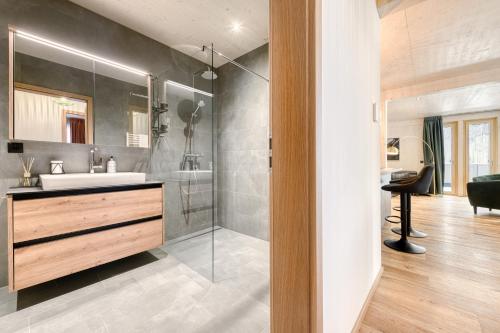 een badkamer met een wastafel en een glazen douche bij Familienferienwohnung Zentral by A-Appartments in Brand
