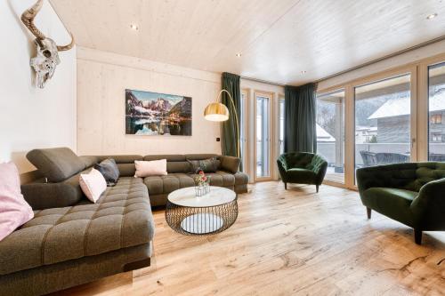 a living room with a couch and a table at Familienferienwohnung Zentral by A-Appartments in Brand
