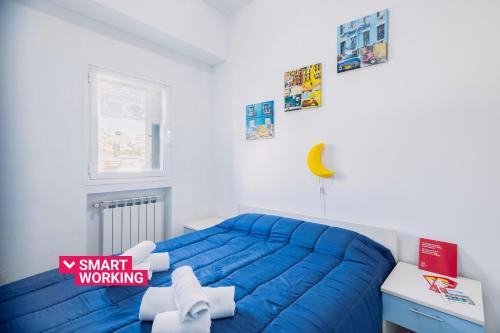 - une chambre avec un lit bleu et une fenêtre dans l'établissement Bijoux Apartment by Wonderful Italy, à Sanremo