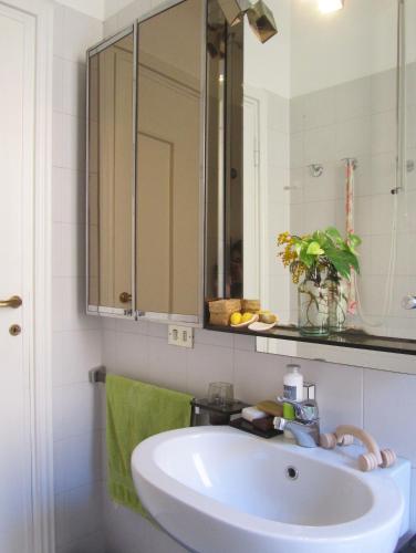 a bathroom with a sink and a mirror at Art Design Duomo Suites in Milan