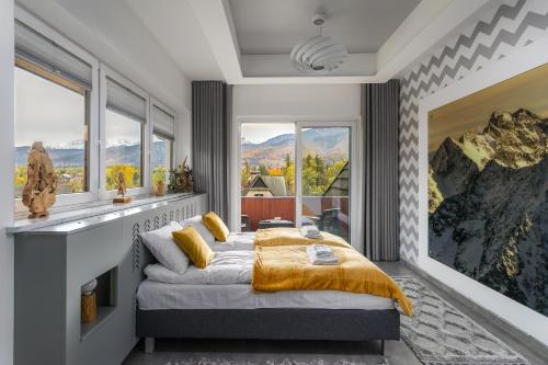 a bedroom with a bed and a large window at Rent like home - Ubocz 1D in Zakopane