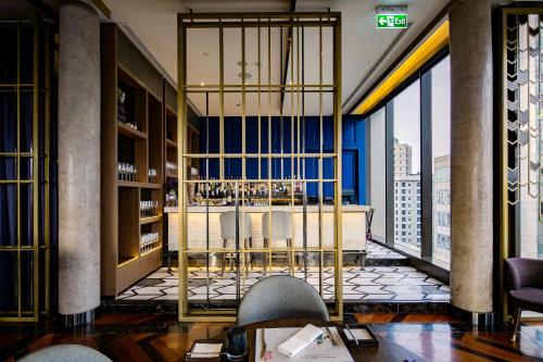 a lobby with a table and chairs in a building at Hotel Indigo Bangkok Wireless Road by IHG in Bangkok