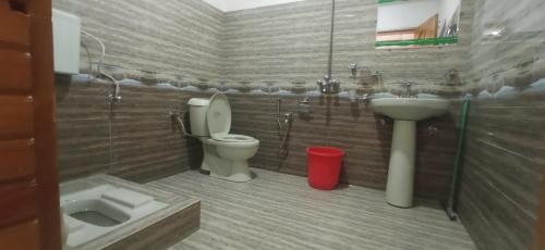 a bathroom with a toilet and a sink at Families Only! Eagle Nest Cottage Muzaffarabad by LMC in Muzaffarabad