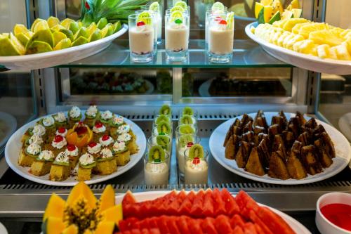 a buffet filled with different types of food on plates at TOA Hotel & Spa Zanzibar in Pongwe
