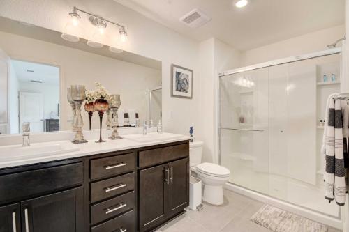 a bathroom with a sink and a shower and a toilet at Spacious Merced Vacation Rental! in Merced