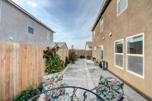 a patio with two chairs and a fence at Spacious Merced Vacation Rental! in Merced