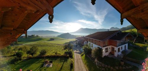 a view of a house on a hill with a farm at Ramslerhof - Chiemgau Karte in Inzell
