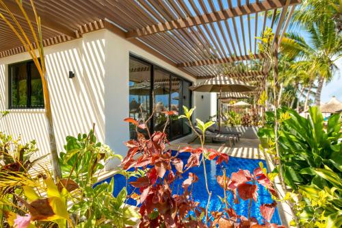 a porch of a house with a blue blanket at TOA Hotel & Spa Zanzibar in Pongwe