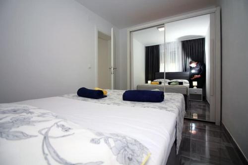 a bedroom with two beds and a living room at Apartments Ane 1 Tisno in Tisno