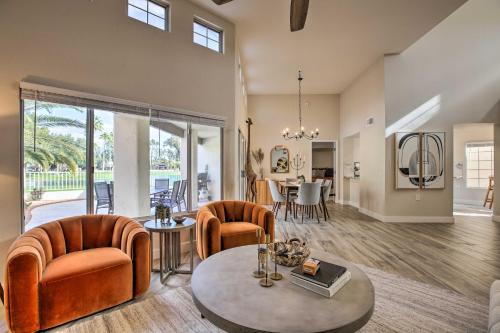 a living room with orange chairs and a table at Golf Course View, Community Perks Surprise Home in Surprise