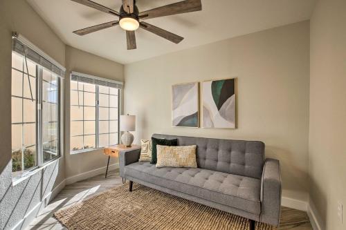 a living room with a couch and a ceiling fan at Golf Course View, Community Perks Surprise Home in Surprise