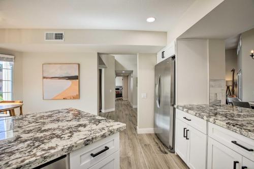 a kitchen with marble counter tops and a refrigerator at Golf Course View, Community Perks Surprise Home in Surprise