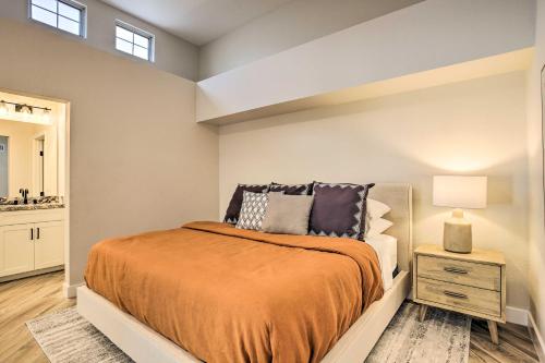 a bedroom with a bed and a table with a lamp at Golf Course View, Community Perks Surprise Home in Surprise