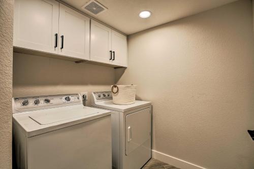 a small laundry room with a washer and dryer at Golf Course View, Community Perks Surprise Home in Surprise