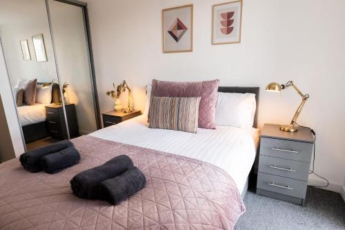 a bedroom with a large bed with two pillows on it at Apartment @ I Quarter in Sheffield