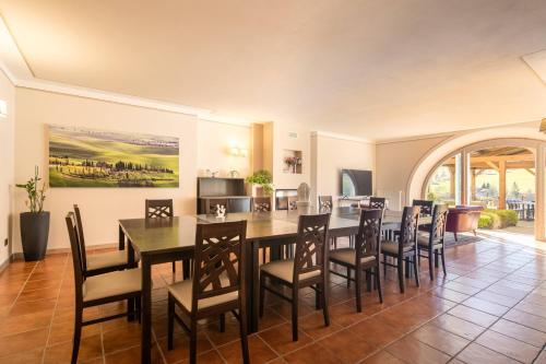 a dining room with a table and chairs at Beautiful villa with private lawn, pool and luxury SPA by VacaVilla in Poppi