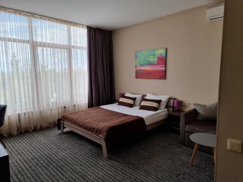Postel nebo postele na pokoji v ubytování Wellotel Yuzhne