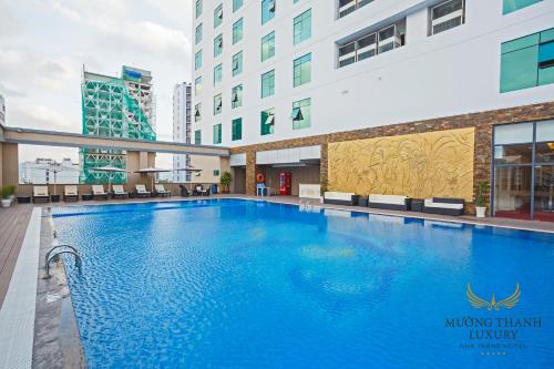 a large swimming pool in the middle of a building at Muong Thanh Luxury Nha Trang Hotel in Nha Trang