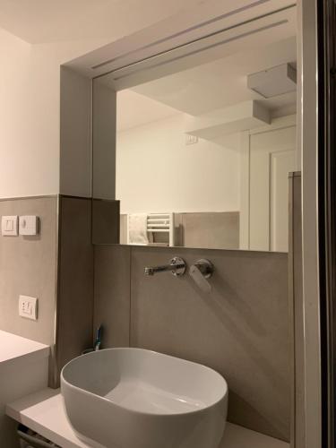a bathroom with a white sink and a mirror at Appartamento al castello di Arco in Arco