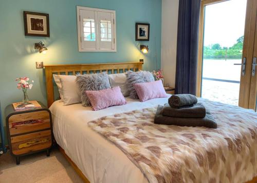 a bedroom with a large bed with pillows and a window at York Marina 