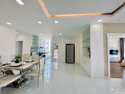 a kitchen and dining room with a table and chairs at Infinity 28 Hotel and Residence in Phnom Penh