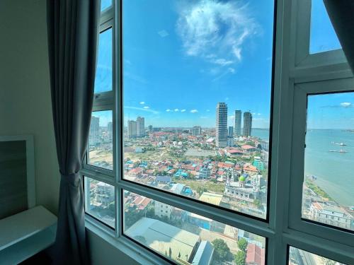 a window view of the city from a hotel room at Infinity 28 Hotel and Residence in Phnom Penh