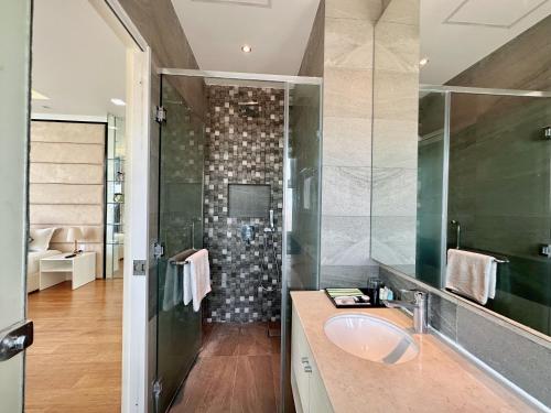 a bathroom with a sink and a shower at Infinity 28 Hotel and Residence in Phnom Penh
