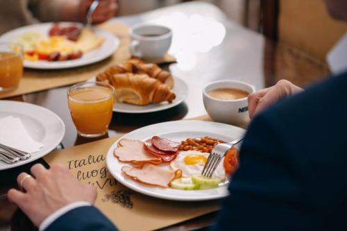 a table with a plate of breakfast food on it at Charles Bridge Palace in Prague