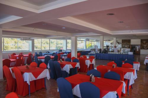 a banquet hall with red and blue tables and chairs at Hotel Sirena Hvar in Hvar