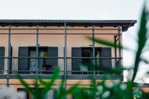 a building with a balcony with a dog on it at Hotel Hvala Superior - Topli Val in Kobarid