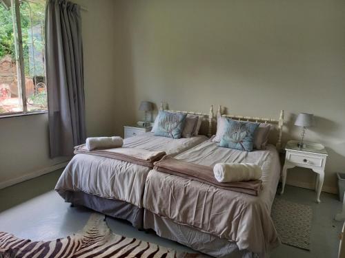 a bedroom with a large bed with blue pillows at Valhalla Ranch in Dundee