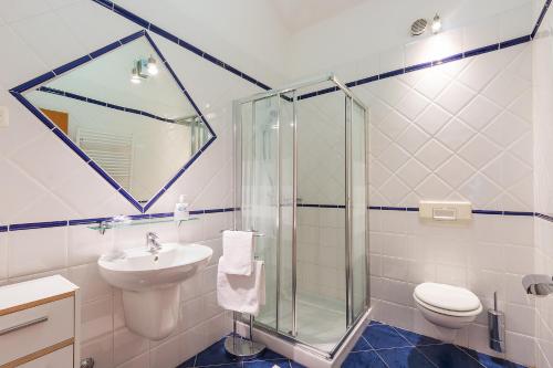 a bathroom with a shower and a sink and a toilet at Villa Alexandra 3 in Pješčana Uvala 