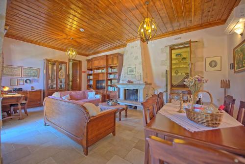 a living room with a couch and a table at Villa Rodanthi by PosarelliVillas in Kástellos