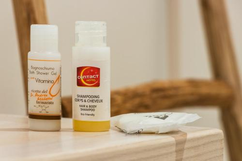two bottles of mustard sitting on a wooden table at ANNA'S DREAM BED & BREAKFAST in Avola