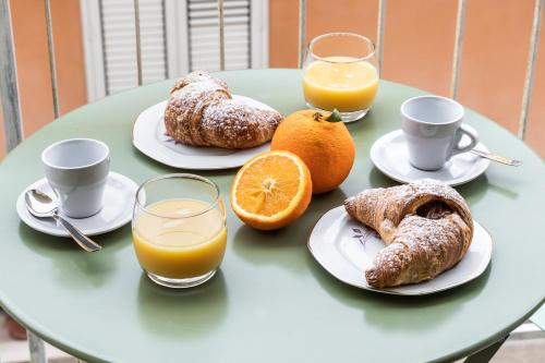a table topped with plates of food and orange juice at ANNA'S DREAM BED & BREAKFAST in Avola